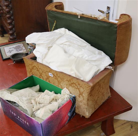 An Edwardian lace dress, a silk girls dress, other various textiles and an ottoman